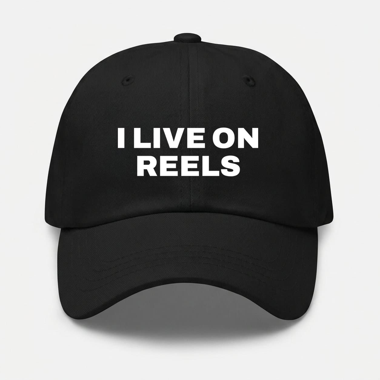 I Live on Reels black cap, front