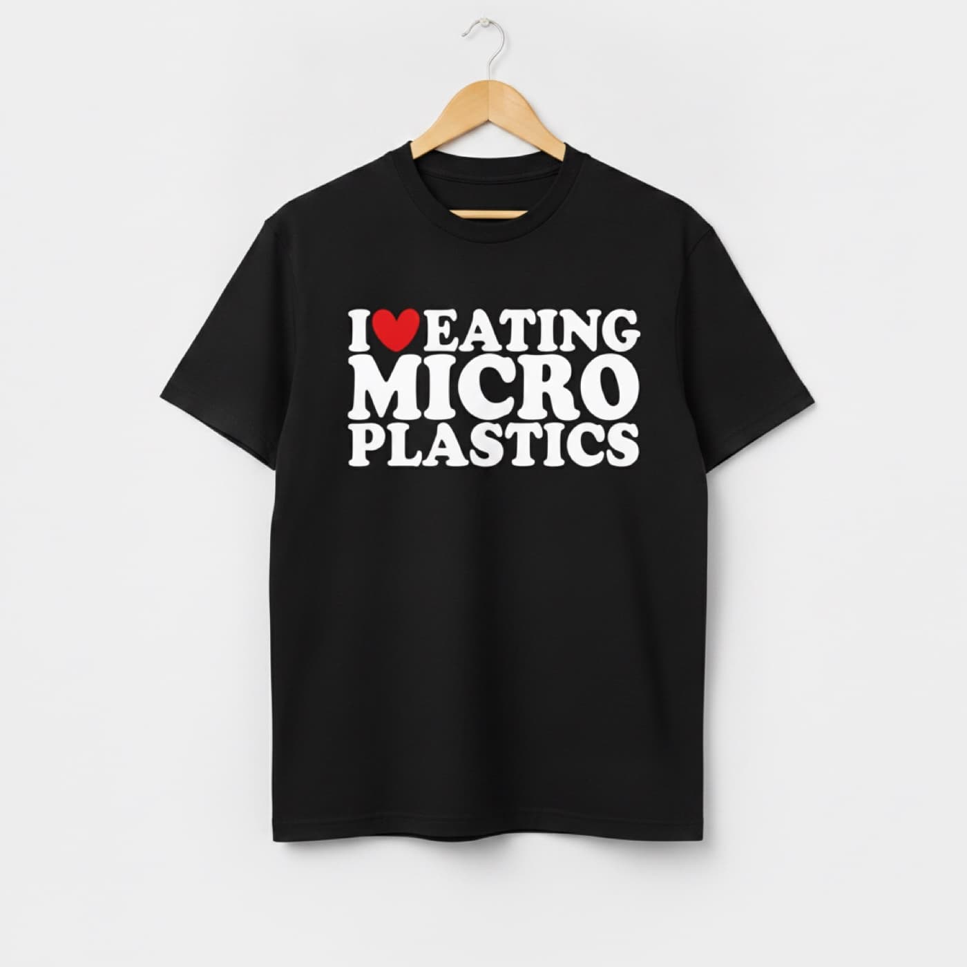 I Love Eating Microplastics t-shirt on a hanger