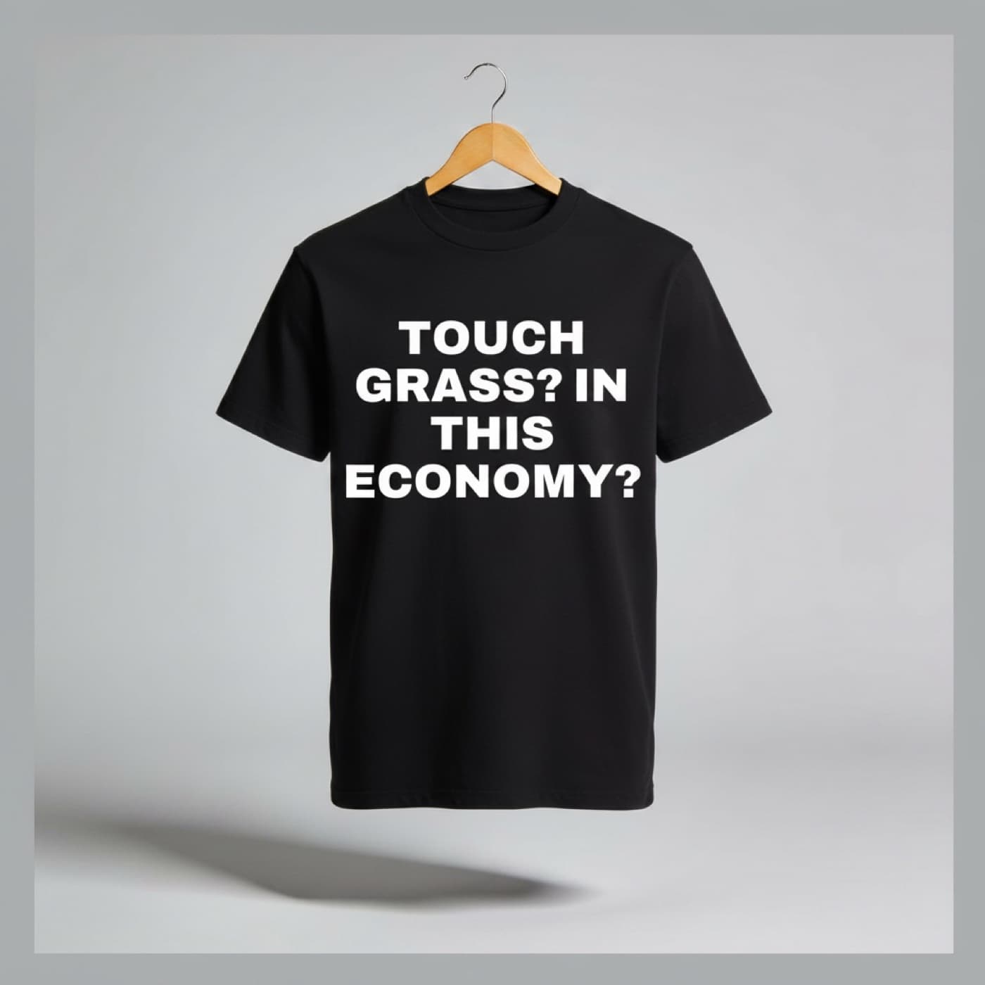 Touch Grass? In This Economy? t-shirt on a hanger
